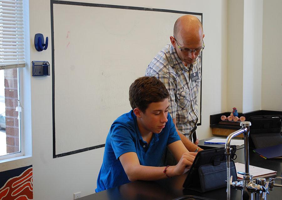 Dr. Weirs helps a student during a freshman biology class.