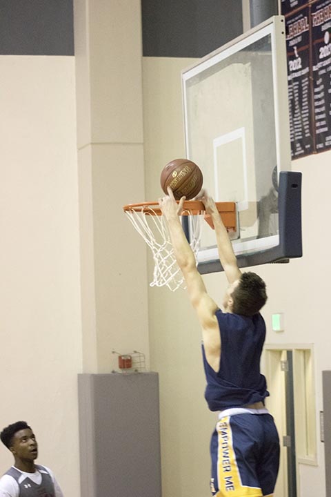  Sean Ingoglia ’18 dunks at the Knights first practice of the season on Monday. Varsitys first game is at St. Ignatius next Wednesday.