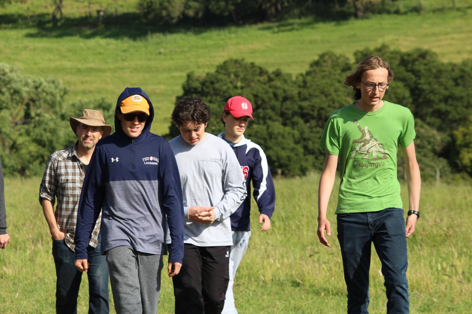 Theo Ennis ’19 and Owen Murray ’20 lead a group of meditators up a trail on the the Ennis familys property. The retreat took place last weekend and was the final retreat of the year.