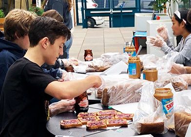 Freshman Vlad Korostoshevskiy helps prepare bag lunches for the homeless on Sept. 15. Although Students in Action organized the first One Less Hungry event of the year, most participants were not members of the club.