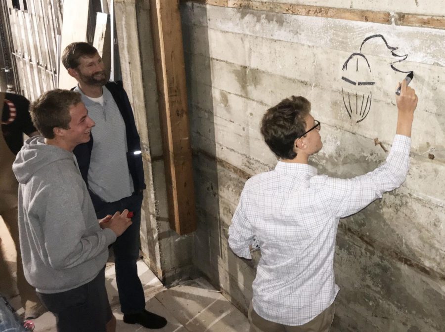 Senior Maxi Tellini draws the Stuart Hall Knight on the concrete of the Columbus Room before the construction crew begins putting up drywall this week. Although the room will be open to the students mid-winter, the kitchen will not be completed until February.