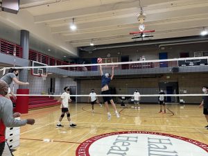Junior Dylan Minvielle blocks serve during practice. Minvielle has neve played voleyball and will be playing the front row middle position for the upcoming season. 