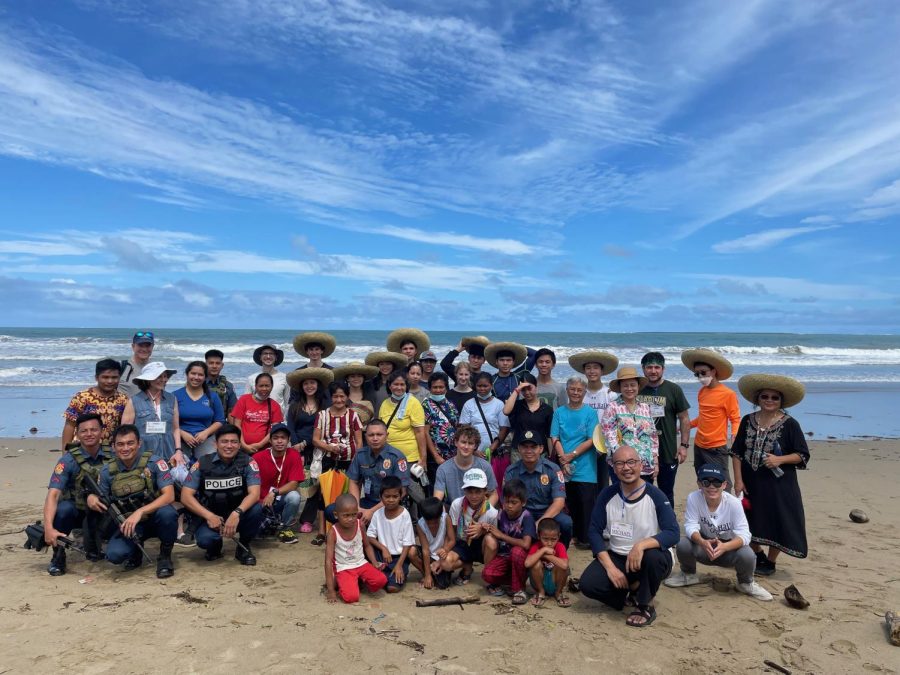 TRIP OF A LIFETIME - Students and teachers visit local village near Sophie's Farm, pictured with locals, RSCJ sisters, and provincial police. The students experienced great connection between themselves and others on this trip. 