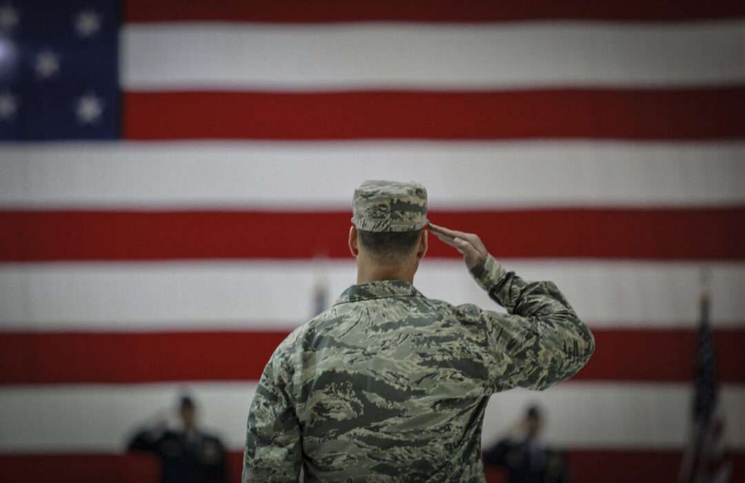 U.S. airmen salutes during an assumption of command ceremony. Original public domain image from Flickr || "The Power of Holidays Like Veterans Day to Unite Us." This Evergreen Home, accessed November 22, 2024. https://thisevergreenhome.com/the-power-of-holidays-like-veterans-day-to-unite-us/.