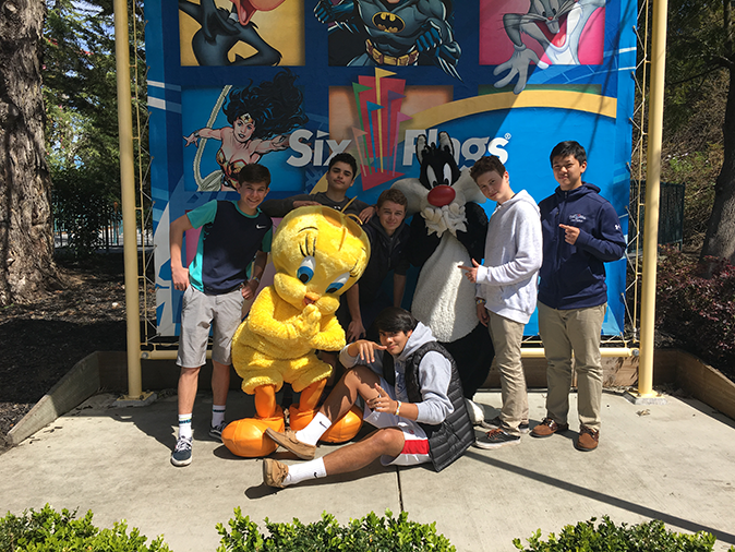 The lacrosse team takes a pic with mascots at Six Flags: Discovery Kingdom before leaving early for their game against Sonoma Academy.