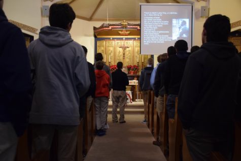 Several rows of students face towards the front of the chapel.