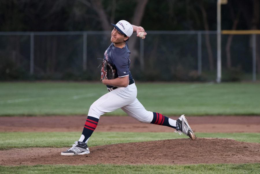 Achilles Arnold '17 delivers a pitch during Friday night's game versus Sonoma Academy. Arnold pitched four innings and received the win with seven strikeouts and only two earned runs.