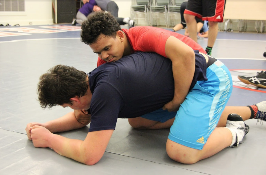 Jonathon Newsome ’19 spars with Andreas Camahort ’19 during practice earlier this week. The wrestling team practices six days a week in the Columbus Room as they prepare to contend for a league and section title.