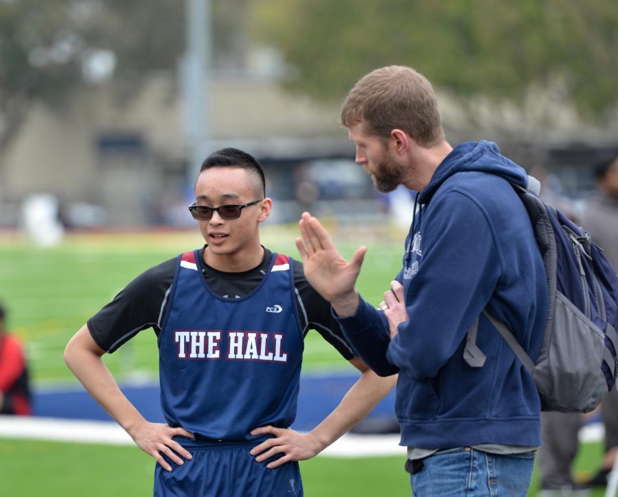 Head Coach Michael Buckley intructs sprinter and jumper Nick Ong ’19 during the King's Academy Invitational track and field meet earlier this month.
Ong has emerged as one of The Hall's top athletes in his third year on the team and looks poised to be a contributor this year and next.