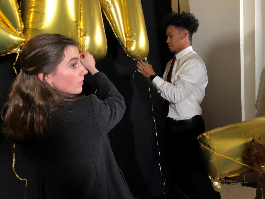 Seniors Wellsley Cohen and Skyler Dela Cruz decorate the Flood Mansions Gallery for Winter Formal on Jan. 25. The gambling-themed annual dance featured snacks, drinks, card games and a dance floor in the
Reception Room.