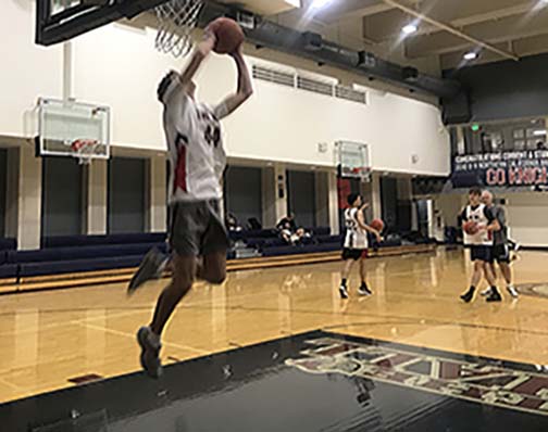 Junior Mac Hatfield shoots a reverse layup during practice in The Dungeon. The Knights began the season without power forward Nigel Burris, who transferred to Archbishop Mitty High School.