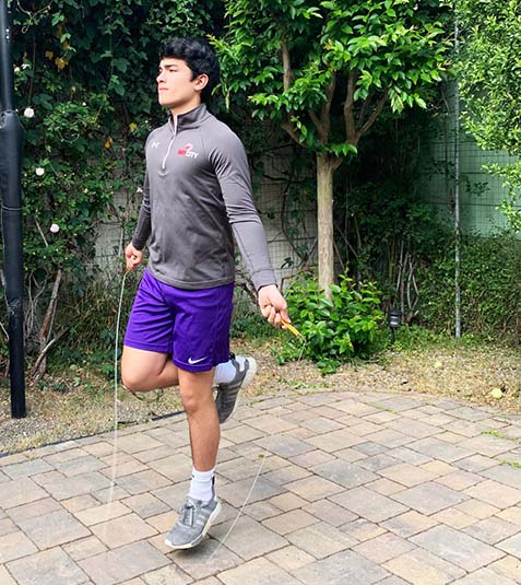 Junior Noah Cross jump ropes as part of his daily workout routine. With athletics canceled and gyms closed, many students began exercising at home to maintain their physical health.
