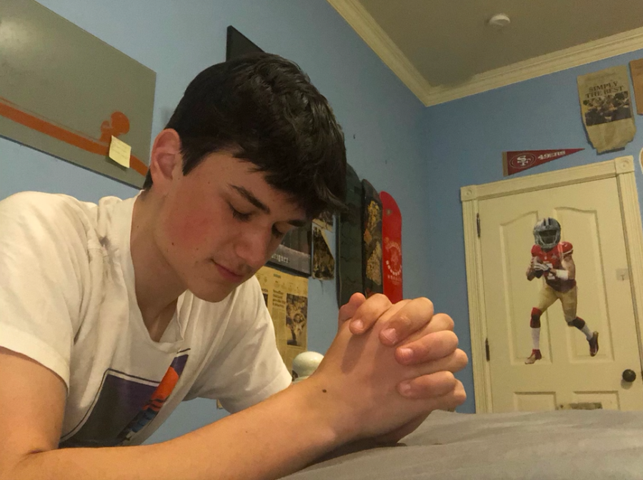 Junior Connor Zanoli prays in his room during lockdown. Christians like Zanoli, as well as other religious students, have been unable to go to church due to social distancing restrictions.