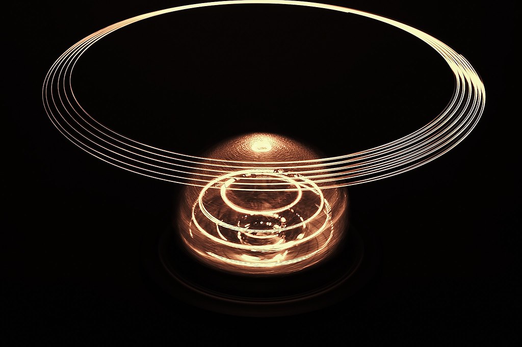 Model created by to model a nuclear fusion reaction. The rings represent the levitating magnetic field which holds superheated plasma in. The bronze spherical object in the middle represents the site at where the fusion reaction occurs.