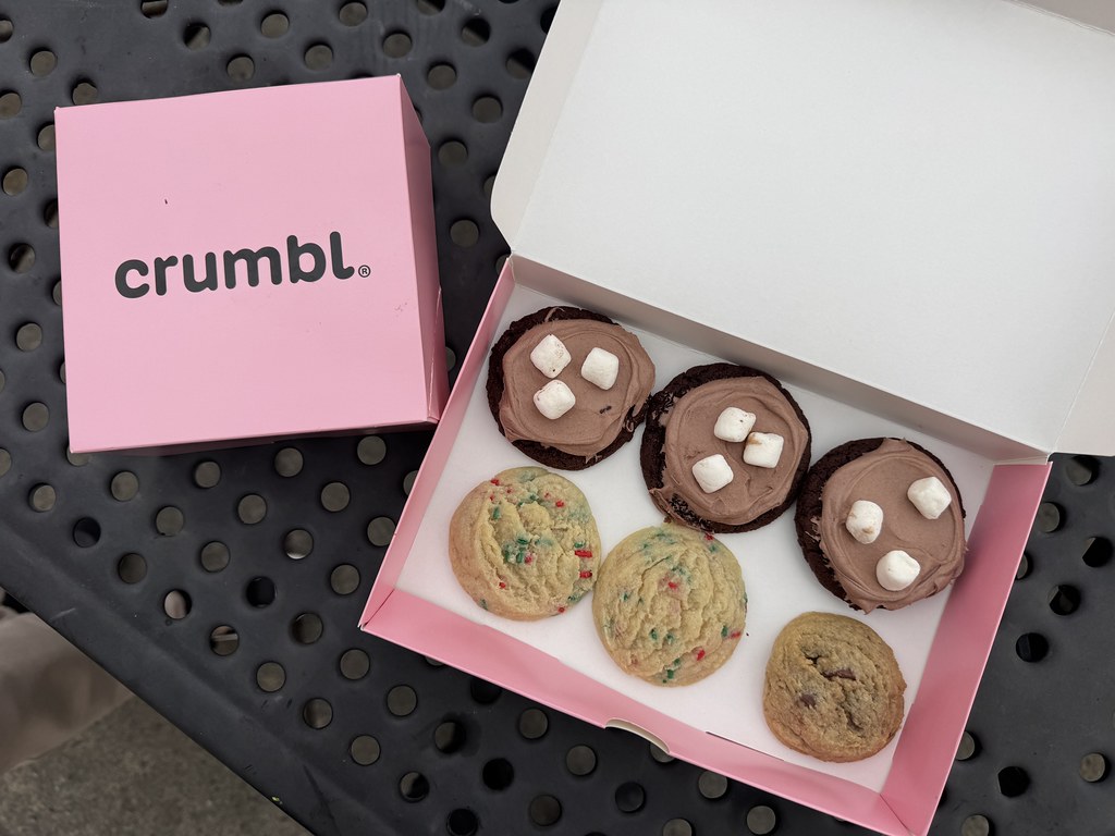 A Crumbl Cookie pack with Frozen Hot Chocolate, Holiday Confetti, and Chocolate Chip.