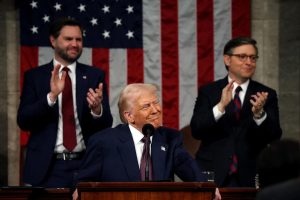 WASHINGTON, DC - MARCH 04: U.S. President Donald Trump addresses a joint session of Congress at the U.S. Capitol on March 04, 2025 in Washington, DC. Vice President JD Vance and Speaker of the House Mike Johnson (R-LA) applaud behind him.