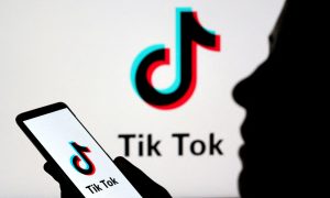 A person holds a smartphone with the Tik Tok logo displayed in this picture illustration taken November 7, 2019.