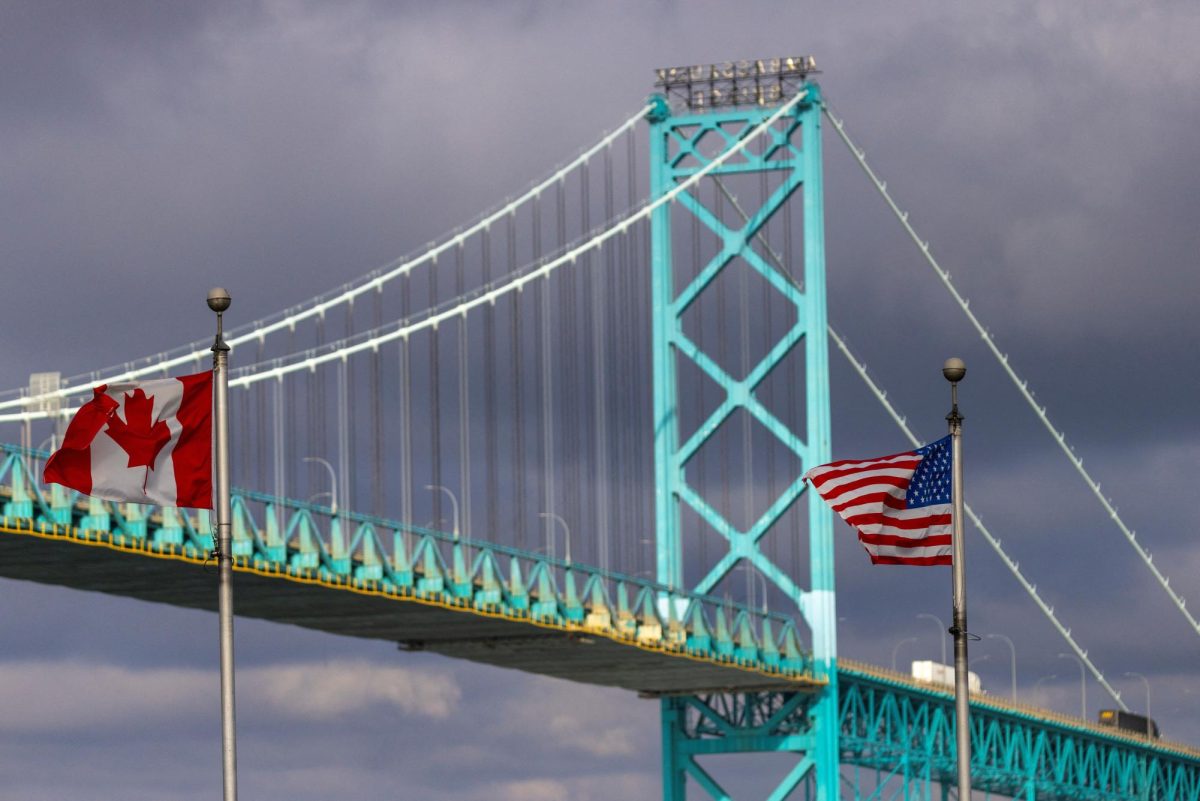 Flags wave in the wind near the Ambassador Bridge which connects Windsor, Ontario, Canada, and Detroit, Michigan, U.S., in Windsor, Ontario, Canada February 4, 2025.