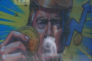 An illustration featuring U.S. President-Donald Trump holding Bitcoin is displayed outside a cryptocurrency exchange store after Bitcoin soars above $100,000, in Hong Kong, China, December 5, 2024. REUTERS/Tyrone Siu