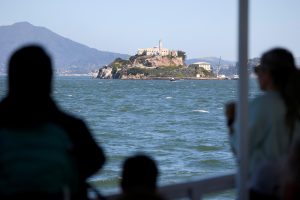 Tourists take photos from a boat taking them to Alcatraz Prison, a National Parks site located on Alcatraz Island in San Francisco Bay in San Francisco, California, U.S. May 5, 2025.  REUTERS/Fred Greaves
