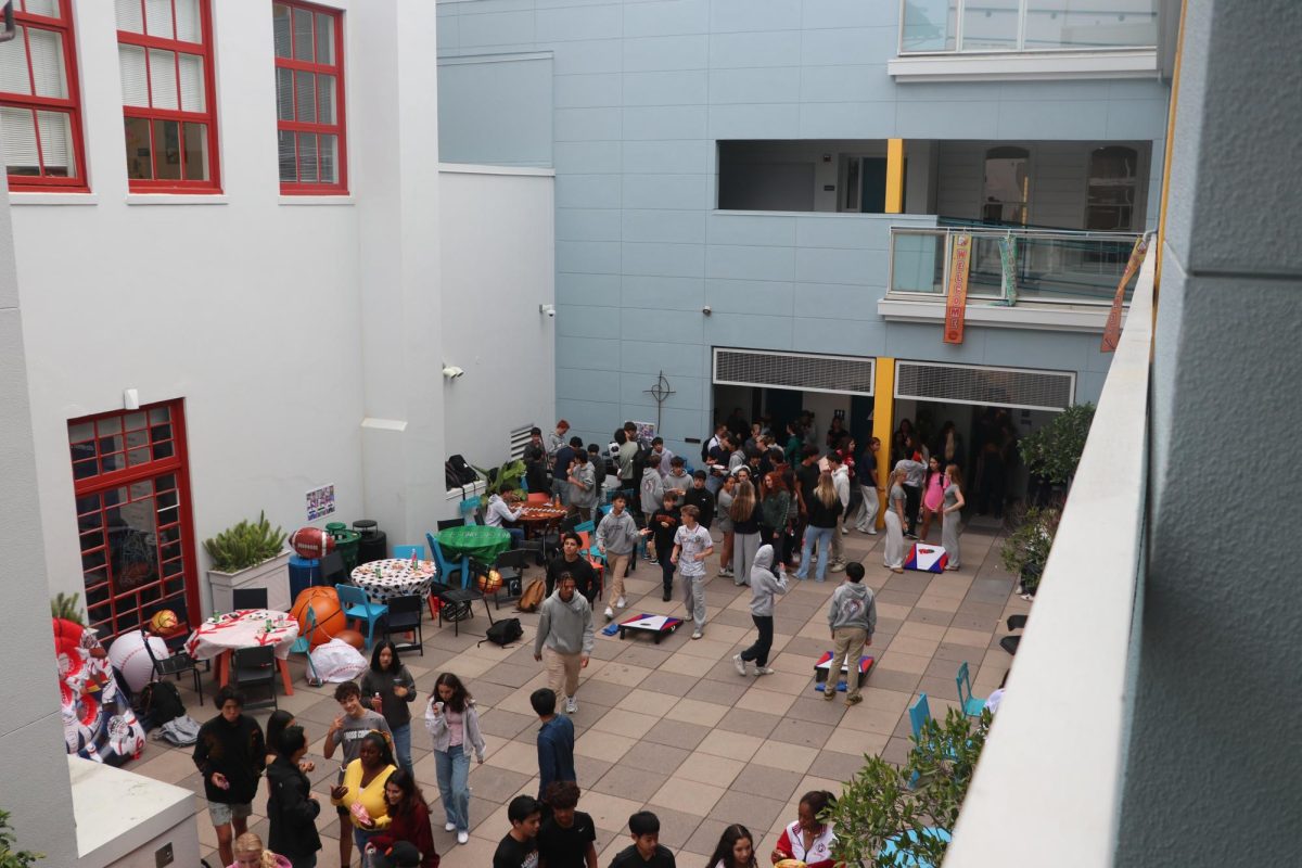 Students eat pizza and Raising Cains and play football toss and cornhole in the Pine-Octavia courtyard at the 2025 Carnival of Champions.