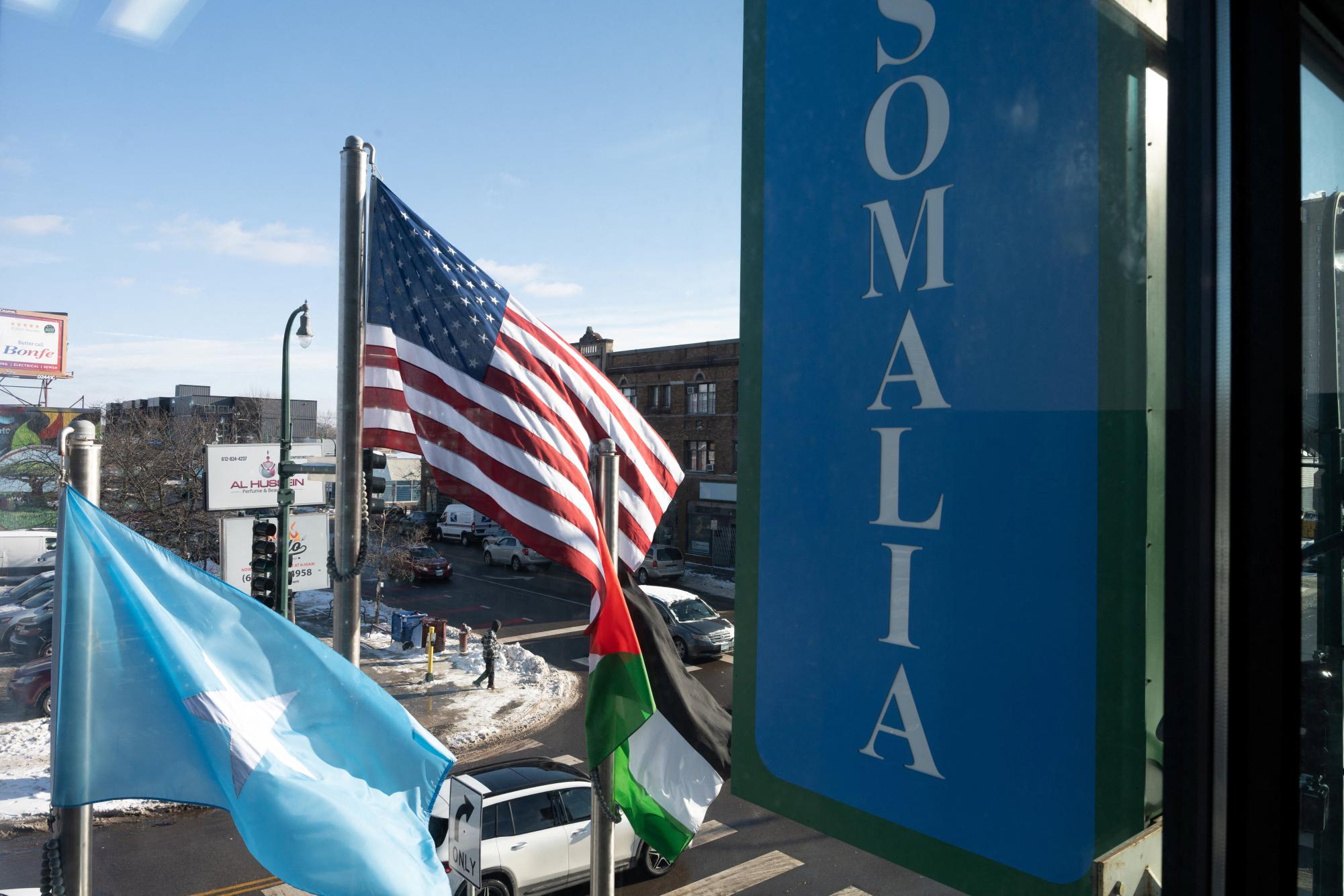 The Somali and American flags fly beside each other outside of Karmel Mall in Minneapolis, Minnesota, U.S. December 3, 2025.  REUTERS/Tim Evans